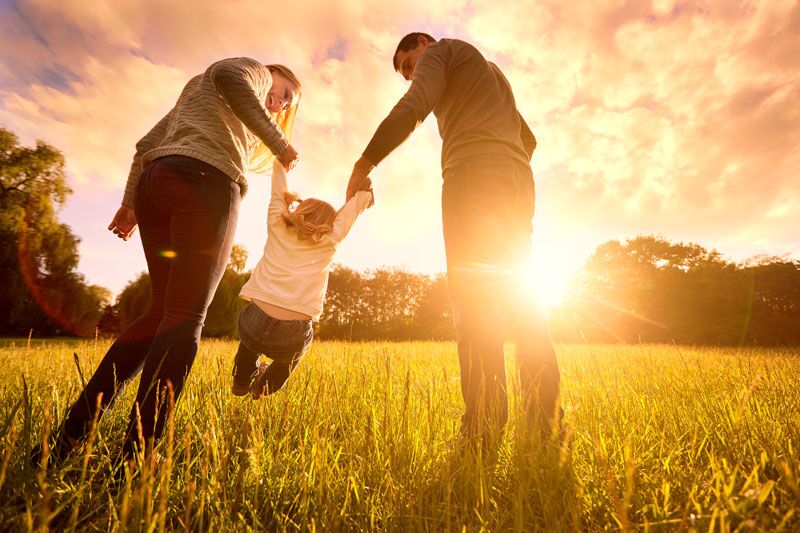 family walking into the sunset