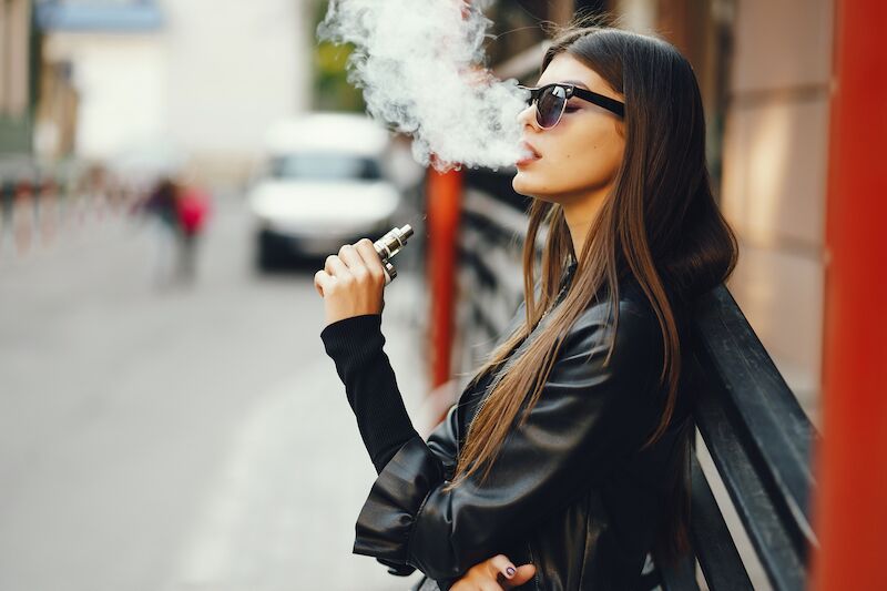 woman in sunglasses vaping