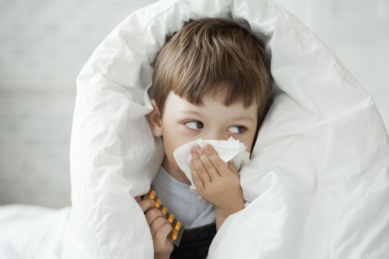 child blowing his nose